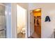 Hallway view of the bathroom, including the toilet and walk-in closet at 8924 N 102Nd Ln, Peoria, AZ 85345