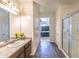 Bright bathroom with a sink, granite counters, and a tiled shower at 8924 N 102Nd Ln, Peoria, AZ 85345