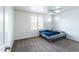 Comfortable bedroom with a ceiling fan, neutral carpet, and natural light from two windows at 8924 N 102Nd Ln, Peoria, AZ 85345