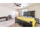 Spacious bedroom with a large bed and modern ceiling fan at 8924 N 102Nd Ln, Peoria, AZ 85345