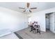 Carpeted bedroom includes ceiling fan, white doors, closet and an open doorway to another room at 8924 N 102Nd Ln, Peoria, AZ 85345