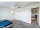 Minimalist bedroom with a ceiling fan, closet, and doorway leading to another room at 8924 N 102Nd Ln, Peoria, AZ 85345