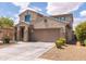 Charming two-story home featuring a well-manicured lawn, tree, and an attached two-car garage at 8924 N 102Nd Ln, Peoria, AZ 85345