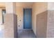 Inviting entryway showcasing a blue front door with decorative trim and textured walls at 8924 N 102Nd Ln, Peoria, AZ 85345