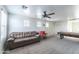 Spacious game room featuring a brown leather sofa, pool table, and neutral carpet in a brightly lit room at 8924 N 102Nd Ln, Peoria, AZ 85345