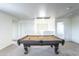 Game room offers pool table, carpet floors and access to a different room through an open doorway at 8924 N 102Nd Ln, Peoria, AZ 85345