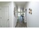 Well-lit hallway with modern decor and beautiful flooring leading to various rooms in the house at 8924 N 102Nd Ln, Peoria, AZ 85345