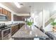 Well-equipped kitchen with a granite island, stainless steel appliances, and stylish cabinetry at 8924 N 102Nd Ln, Peoria, AZ 85345