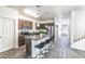 Open kitchen layout boasts an island with seating, stainless steel appliances, and ample cabinet space at 8924 N 102Nd Ln, Peoria, AZ 85345