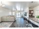 Comfortable living room featuring an open layout and flowing into kitchen with breakfast bar seating at 8924 N 102Nd Ln, Peoria, AZ 85345