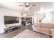 Open-concept living room with an adjacent kitchen and comfortable seating at 8924 N 102Nd Ln, Peoria, AZ 85345