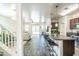Open-concept living space showcasing a modern kitchen with a breakfast bar and a cozy living room at 8924 N 102Nd Ln, Peoria, AZ 85345