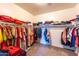 Large walk-in closet with ample shelving and hanging space at 8924 N 102Nd Ln, Peoria, AZ 85345