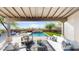 Inviting covered patio with comfortable seating overlooking the sparkling pool and lush backyard at 9669 E Chino Dr, Scottsdale, AZ 85255