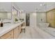 A modern bathroom features dual sinks, a soaking tub, and a glass-enclosed shower at 9669 E Chino Dr, Scottsdale, AZ 85255