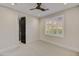 Simple bedroom with a window and ceiling fan; freshly painted and carpeted at 9669 E Chino Dr, Scottsdale, AZ 85255
