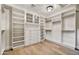 A walk-in closet includes built in shelving and drawers with a light fixture at 9669 E Chino Dr, Scottsdale, AZ 85255