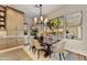 An elegant dining room is furnished with a wood table, seating, and a stylish light fixture at 9669 E Chino Dr, Scottsdale, AZ 85255