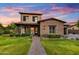 Beautiful two-story home featuring a well-manicured lawn, brick accents, and charming curb appeal at 9669 E Chino Dr, Scottsdale, AZ 85255