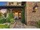 Charming front porch with brick accents, lush greenery, and welcoming entrance, great curb appeal at 9669 E Chino Dr, Scottsdale, AZ 85255
