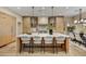 Bright, modern kitchen features a large island, stylish lighting, and stainless steel appliances for gourmet cooking at 9669 E Chino Dr, Scottsdale, AZ 85255