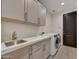 Convenient laundry room featuring a sink, counter space, and appliances at 9669 E Chino Dr, Scottsdale, AZ 85255
