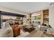 The open living room has hardwood floors and a fireplace, with views of the outdoor patio at 9669 E Chino Dr, Scottsdale, AZ 85255