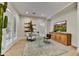 A home office with a clear desk, TV, and a cabinet offers a clean workspace at 9669 E Chino Dr, Scottsdale, AZ 85255