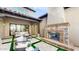 Outdoor patio with a brick fireplace, comfortable seating, and a view of the backyard at 9669 E Chino Dr, Scottsdale, AZ 85255