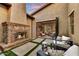 Cozy patio with outdoor seating, a brick fireplace, and seamless indoor/outdoor flow at 9669 E Chino Dr, Scottsdale, AZ 85255