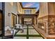 Inviting patio with fireplace, seating, and artificial grass accents at 9669 E Chino Dr, Scottsdale, AZ 85255