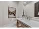 Stylish powder room featuring a modern vanity, herringbone tile floors, and elegant decor at 9669 E Chino Dr, Scottsdale, AZ 85255