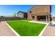 Backyard with a turfed lawn, a putting green and a covered patio at 9837 E Satellite Dr, Mesa, AZ 85212