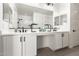 Double vanity in the main bathroom with sleek black faucets and modern cabinets at 9837 E Satellite Dr, Mesa, AZ 85212