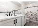 Bathroom with white cabinets, a floral shower curtain, and black hardware at 9837 E Satellite Dr, Mesa, AZ 85212