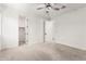 Bright bedroom with a ceiling fan, carpeted floors and a walk-in closet at 9837 E Satellite Dr, Mesa, AZ 85212
