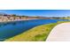Scenic view of a community lake, showcasing the well-maintained landscaping and attractive homes in the neighborhood at 9837 E Satellite Dr, Mesa, AZ 85212