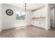 Bright dining area featuring white cabinets, subway tile backsplash and natural light at 9837 E Satellite Dr, Mesa, AZ 85212