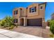 Two-story home featuring a desert landscape, tan stucco and a two car garage in a sunny neighborhood at 9837 E Satellite Dr, Mesa, AZ 85212