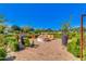 Charming outdoor fire pit area with chairs and manicured hedges, creating a cozy gathering spot at 9837 E Satellite Dr, Mesa, AZ 85212
