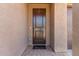 A covered front porch with a decorative wooden door and a 