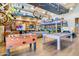 Fun game room featuring pool tables, foosball, and quirky vintage decor, perfect for social gatherings at 9837 E Satellite Dr, Mesa, AZ 85212