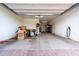 Open garage with a concrete floor, a garage door, and an electrical vehicle charger at 9837 E Satellite Dr, Mesa, AZ 85212