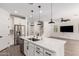 Open kitchen featuring stainless steel appliances, white cabinets and a center island with sink at 9837 E Satellite Dr, Mesa, AZ 85212