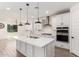 Modern kitchen featuring a center island with a sink, white cabinetry, and stainless steel appliances at 9837 E Satellite Dr, Mesa, AZ 85212