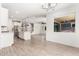 Open concept living area featuring wood-look tile floors and plenty of natural light at 9837 E Satellite Dr, Mesa, AZ 85212