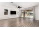 Open-concept living room with tile floors, recessed lighting, and access to the backyard at 9837 E Satellite Dr, Mesa, AZ 85212