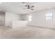 Upstairs carpeted loft area featuring ceiling fan and plenty of natural light at 9837 E Satellite Dr, Mesa, AZ 85212