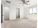 Bright main bedroom featuring a ceiling fan, carpeted floors, and a window for natural light at 9837 E Satellite Dr, Mesa, AZ 85212