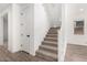 Staircase with carpeted steps and white railing, complemented by wood-look flooring and natural light at 9837 E Satellite Dr, Mesa, AZ 85212